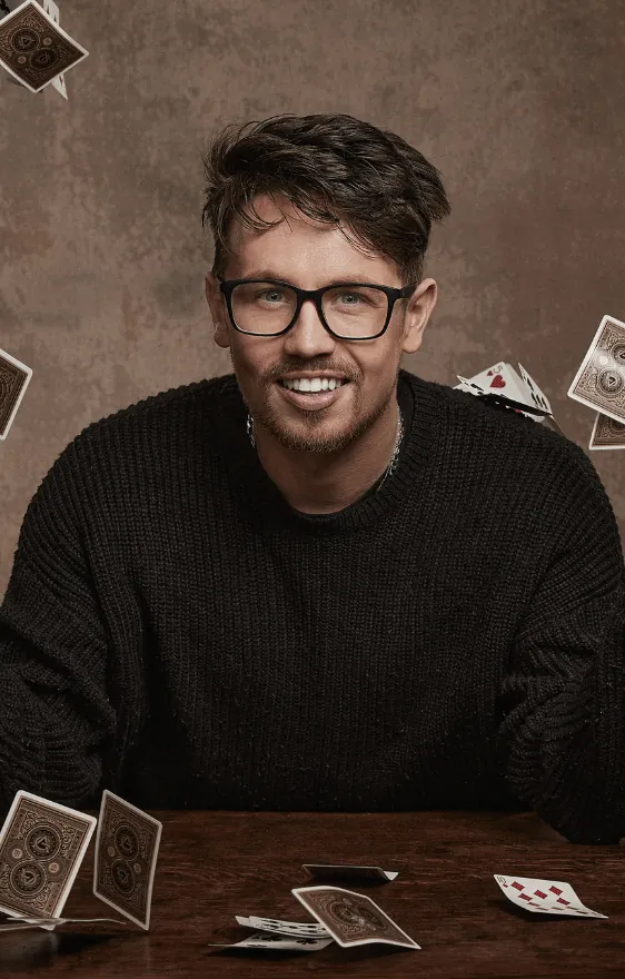 James Phelan throwing playing cards into the air