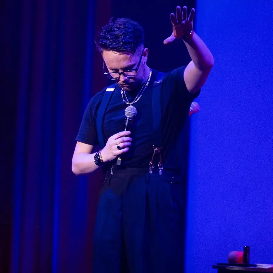 Mic in hand, mid-show