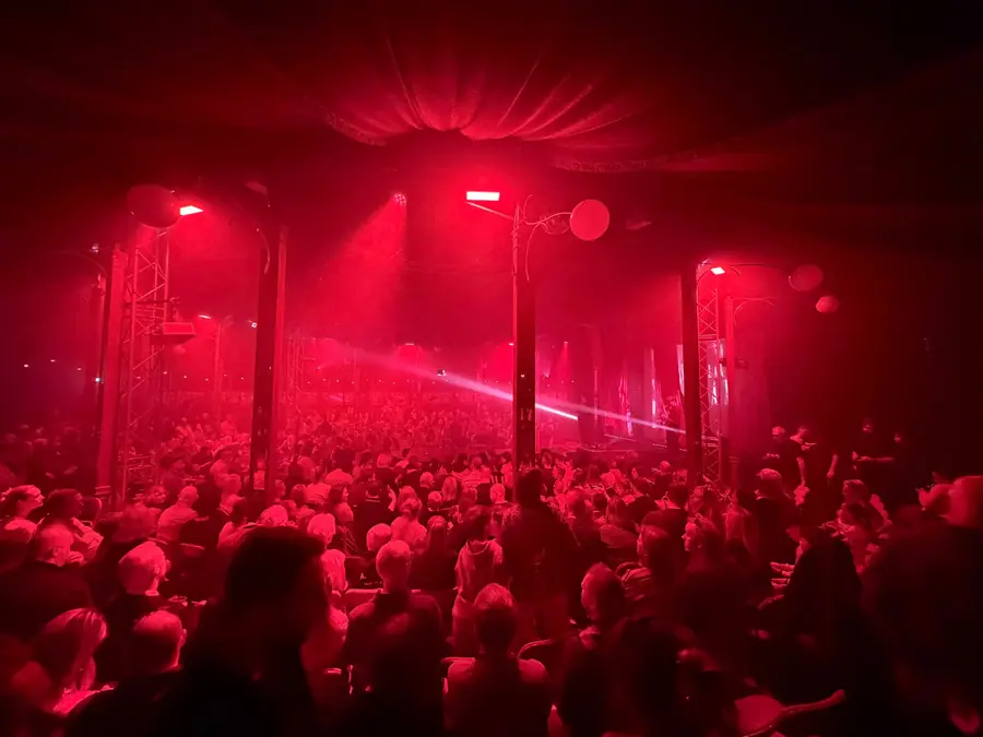 A red-lit crowd